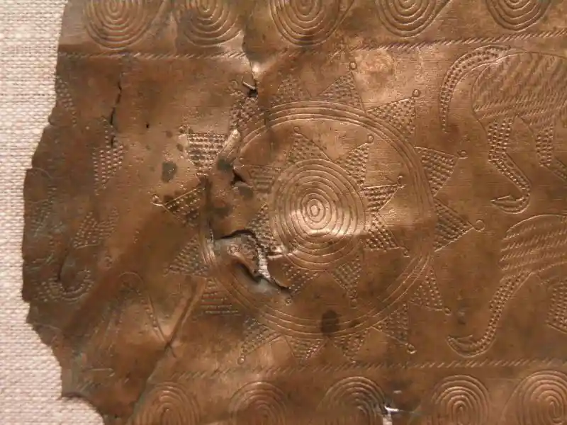 A solar disc design on a bronze metal sheet